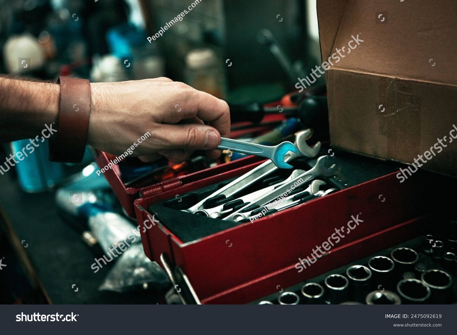 stock-photo-man-hand-and-tool-box-for-repair-service-spanner-and-mechanic-for-maintenance-in-garage-male-2475092619